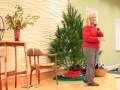 Children, youth and parents decorating the Mitten Tree with hats, scarves, gloves and mittens.