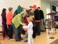 Children decorating Mitten Tree.