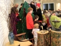 Children decorating Mitten Tree.