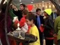 Children decorating Mitten Tree.