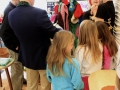Children decorating Mitten Tree.