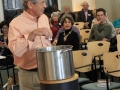 Putting vegetables in the Stone Soup pot.