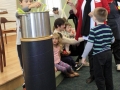Putting vegetables in the Stone Soup pot.