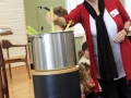 Putting vegetables in the Stone Soup pot.
