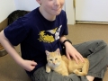Youth interacting with cat.